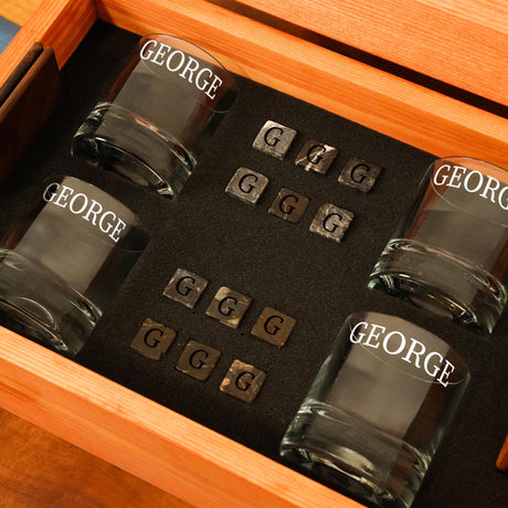 a set of four glasses in a wooden box