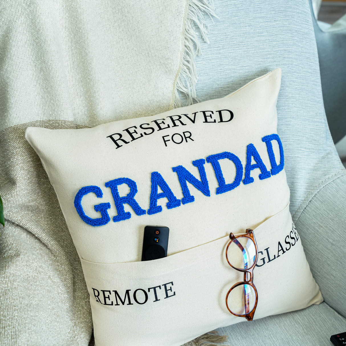 a pillow that says reserved for grandad on it