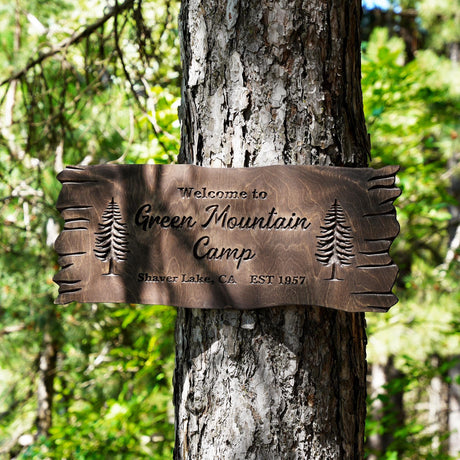 a welcome sign on a tree in a forest