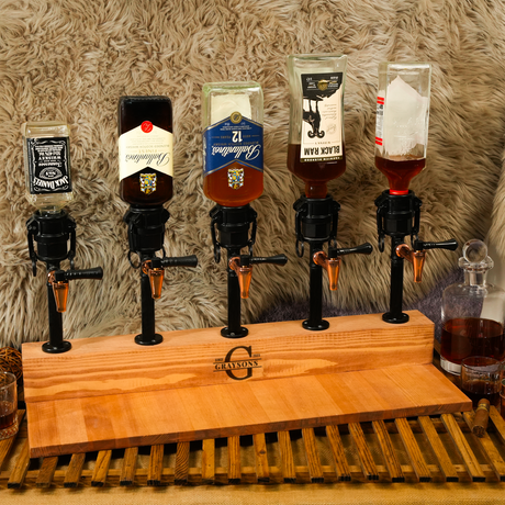 Set of five cocktail mixers on a wooden stand with a textured wall background