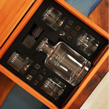 a couple of glass bottles sitting inside of a wooden box