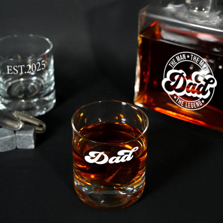 a glass of whiskey next to a bottle of dad&#39;s whiskey