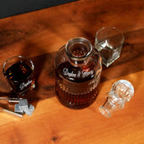 a bottle of liquor sitting on top of a wooden table