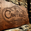 a wooden sign on the side of a stone wall