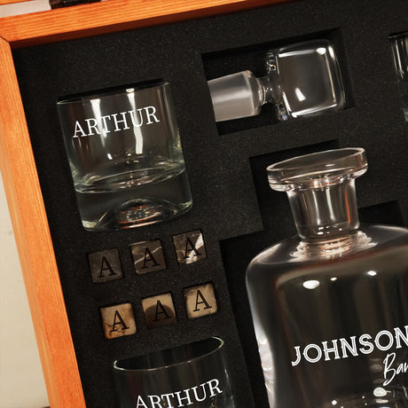 a bottle of alcohol and shot glasses in a wooden box