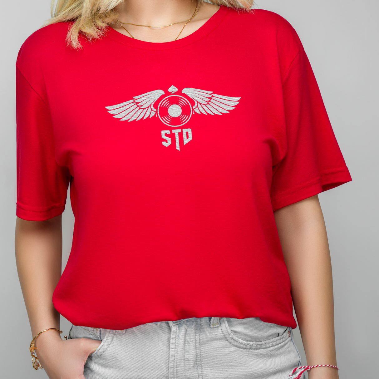 a woman with blonde hair, wearing a red pilot T-shirt