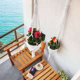 a couple of hanging planters filled with flowers