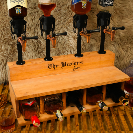 Wooden bar tap system with 'The Browns Bar' branding, featuring beer bottles and glasses.