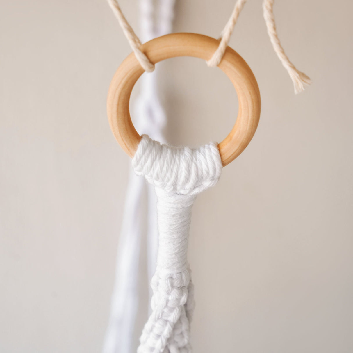 a close up of a wooden ring on a string