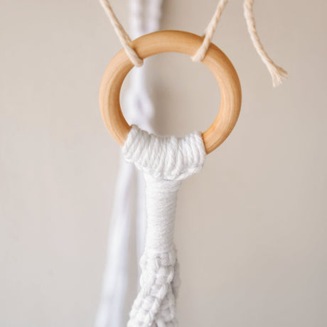 a close up of a wooden ring on a string