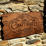 a wooden sign that reads craft beer on a stone wall