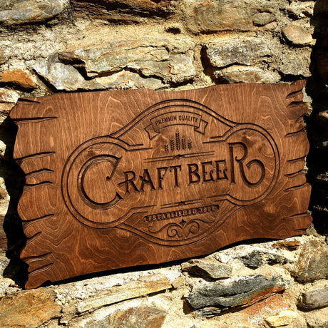 a wooden sign that reads craft beer on a stone wall