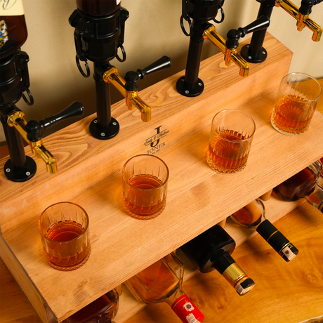 Wooden bar with beer taps and glasses filled with amber liquid