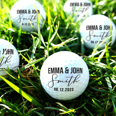 Personalized golf balls with 'Emma & John Smith' and a date on grass