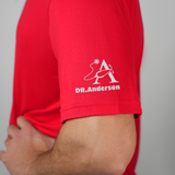 arm view of a man wearing a red dental shirt