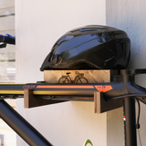 close-up of a wall-mounted bicycle holder with helmet and bicycle on it