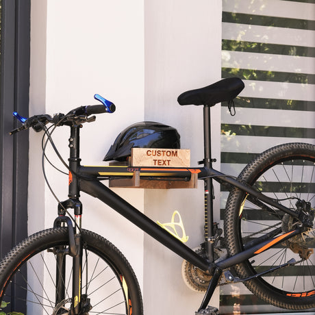 a wall-mounted bicycle holder with bicycle and helmet on it