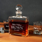 a bottle of brown is next to two shot glasses