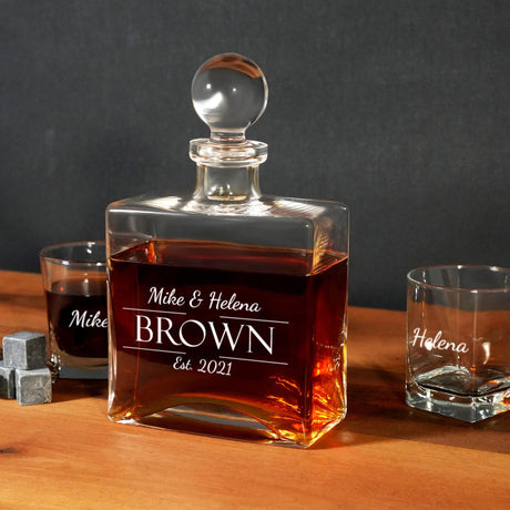 a bottle of brown is next to two shot glasses