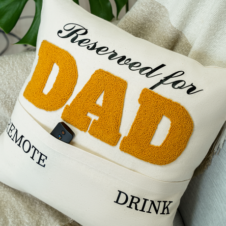 a pillow that says reserved for dad on it