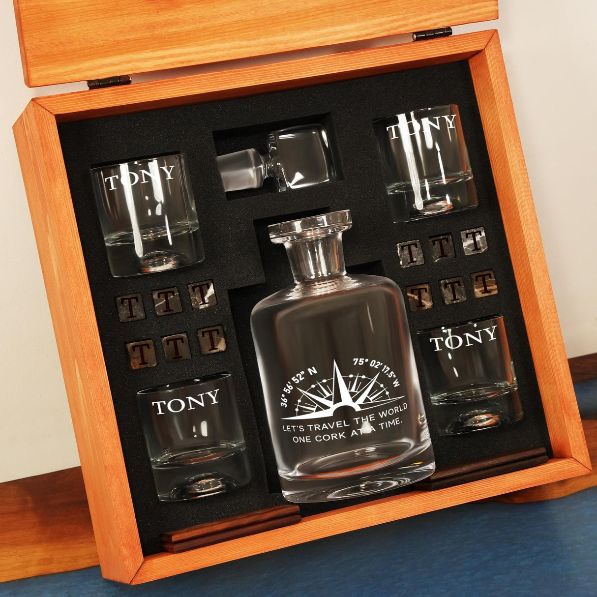 a wooden box with a bottle of liquor and shot glasses