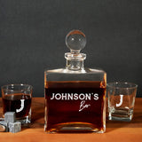 a bottle of whiskey sitting next to two shot glasses