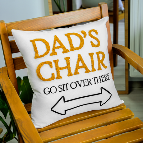 a chair with a pillow that says dad's chair go sit over there