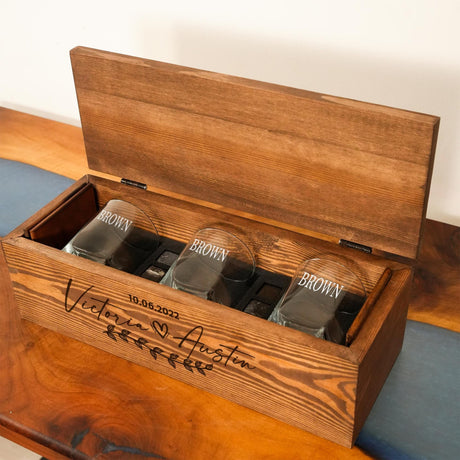 a wooden box with four shot glasses in it