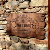 a wooden sign on a stone wall that says ratt beer