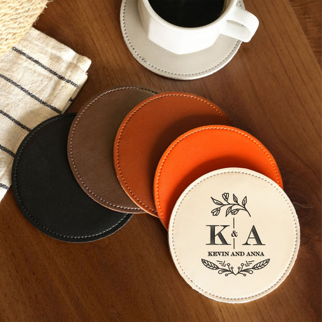 a wooden table topped with four coasters next to a cup of coffee