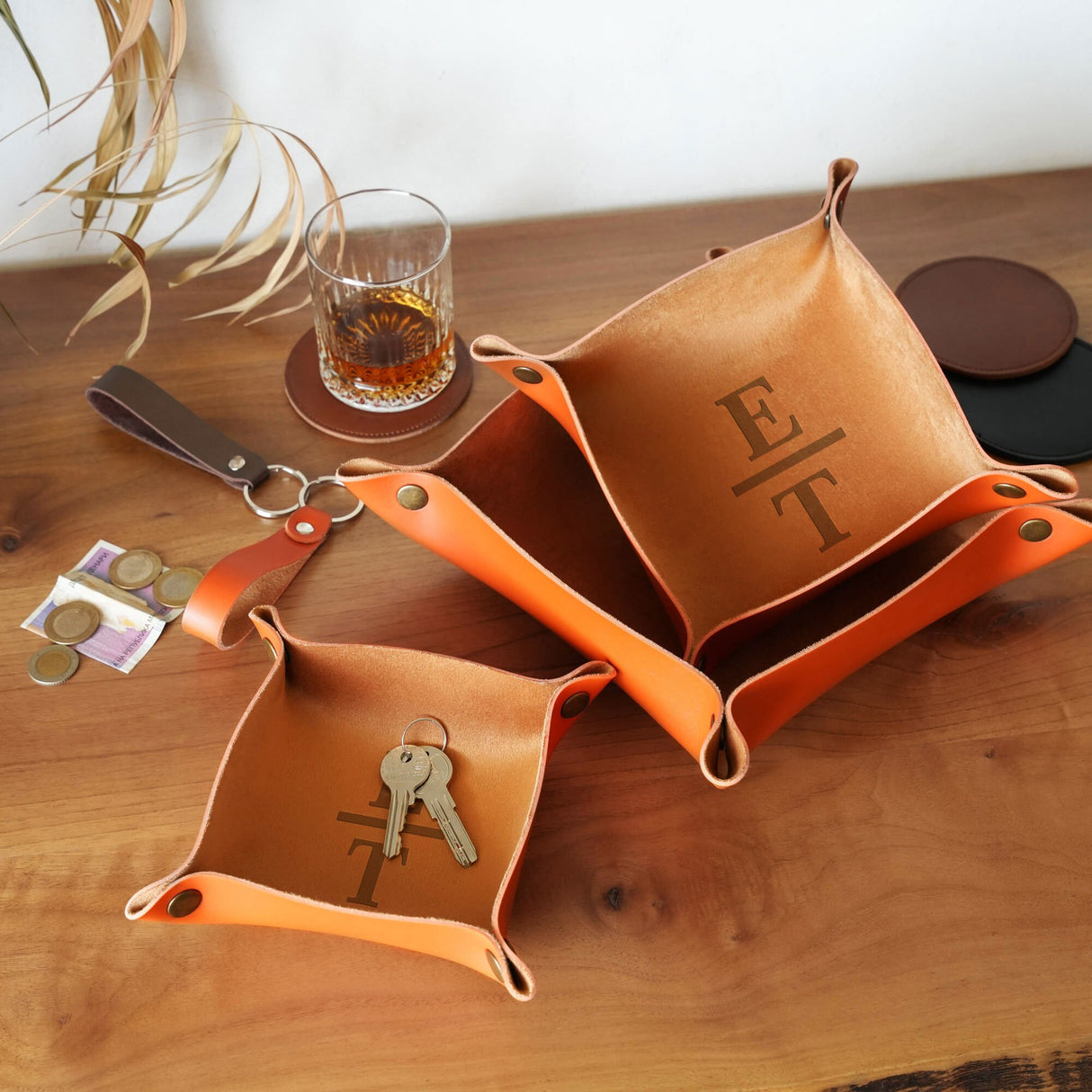 a couple of orange bags sitting on top of a wooden table