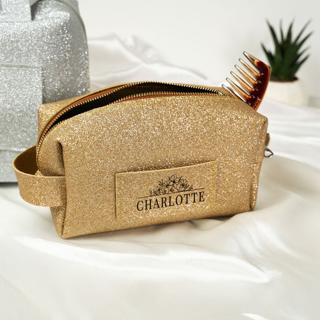 a gold cosmetic bag with a comb in it