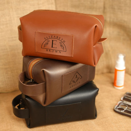 a brown leather pouch sitting on top of a black leather case