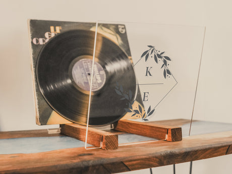 a record player on a table with a wooden stand