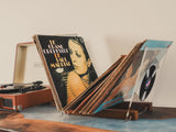 a record player sitting on top of a wooden table