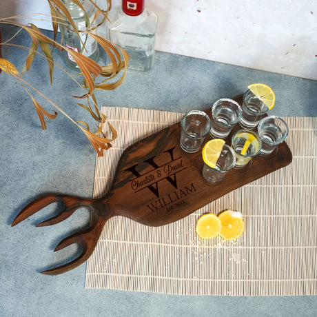 a wooden tray with glasses and lemons on it