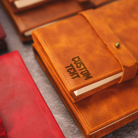 a brown leather notebook sitting on top of a table