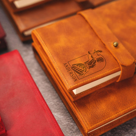 a brown leather notebook with a motorbike on it