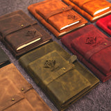 a variety of leather notebooks lined up on a carpet