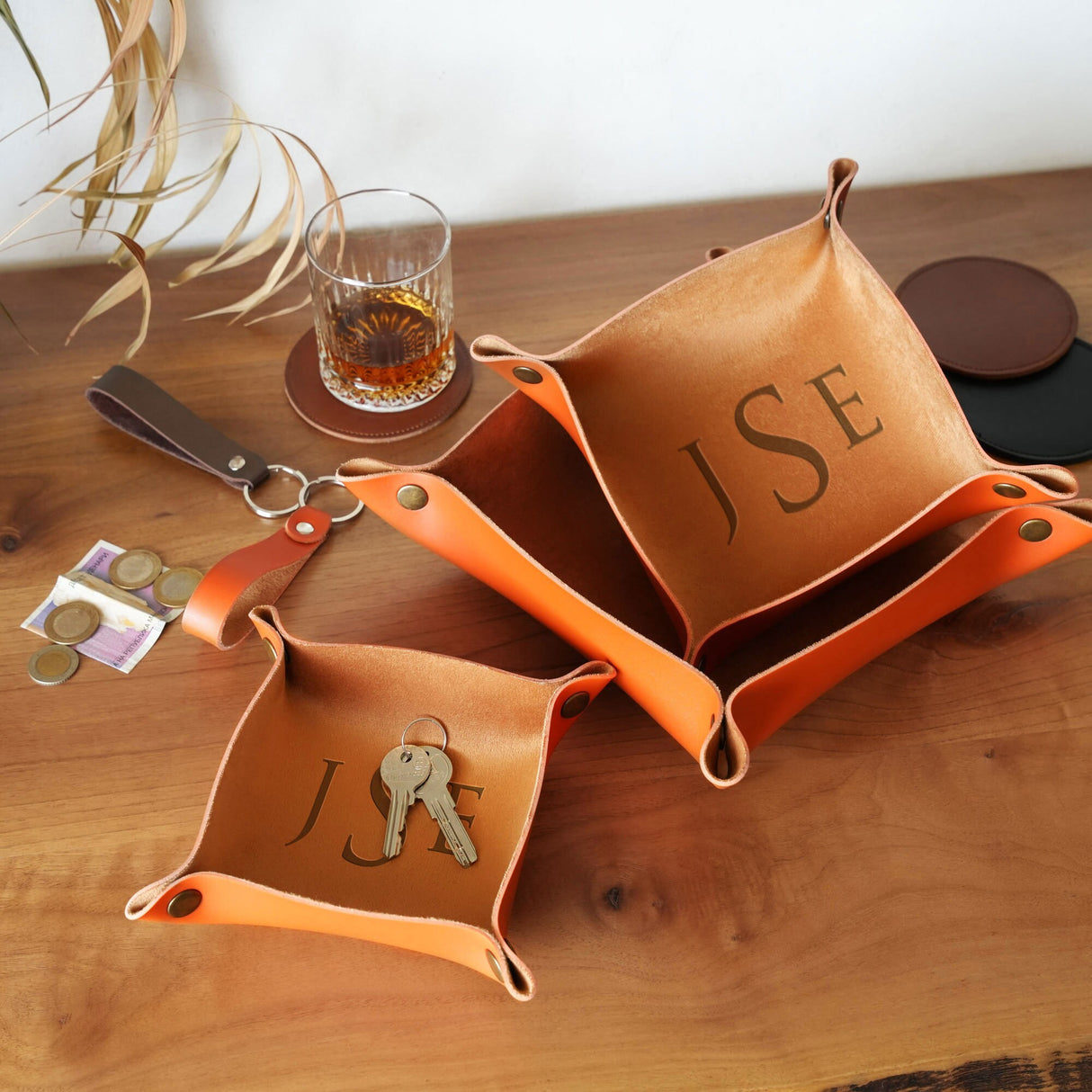 a couple of orange bags sitting on top of a wooden table