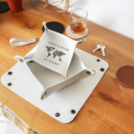 a table with a glass of alcohol and a plate with a map on it