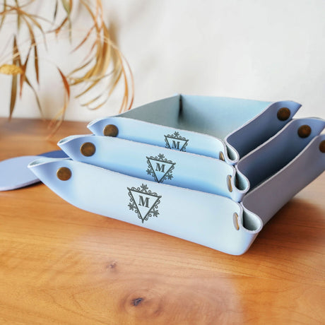 a set of four blue dishes sitting on top of a wooden table