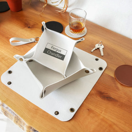 a wooden table topped with a glass of alcohol