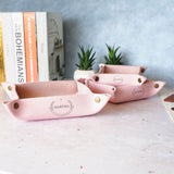 a couple of pink trays sitting on top of a counter