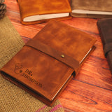 a brown leather notebook sitting on top of a wooden table