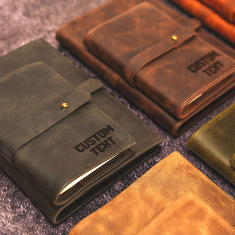 a group of leather notebooks sitting on top of a carpet