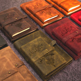 a group of leather notebooks sitting on top of a carpet