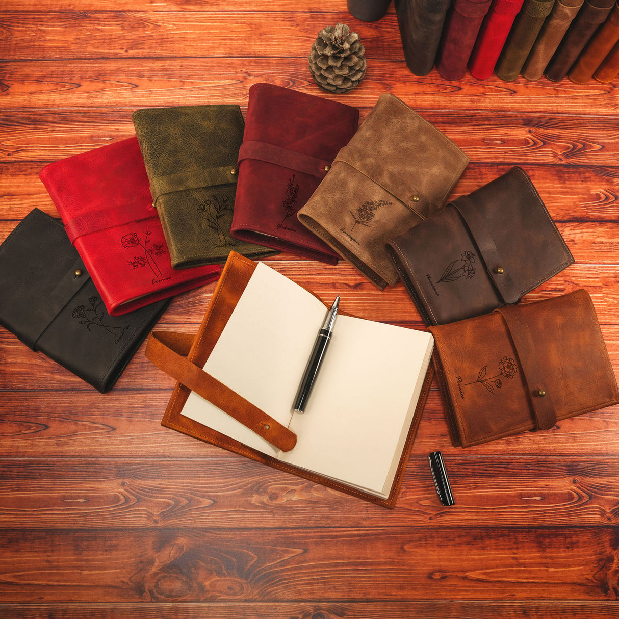 a notebook and pen sitting on top of a wooden floor