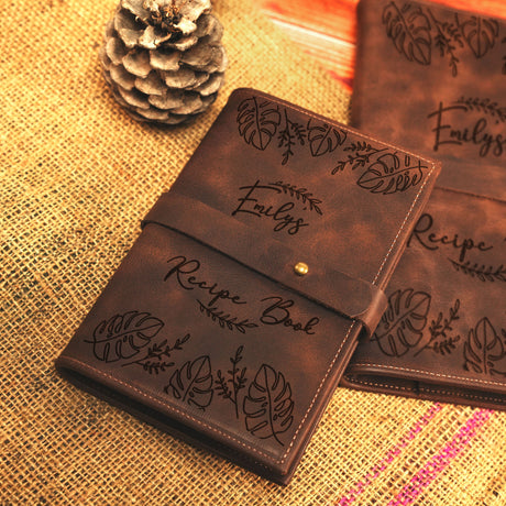 a couple of brown wallets sitting on top of a table