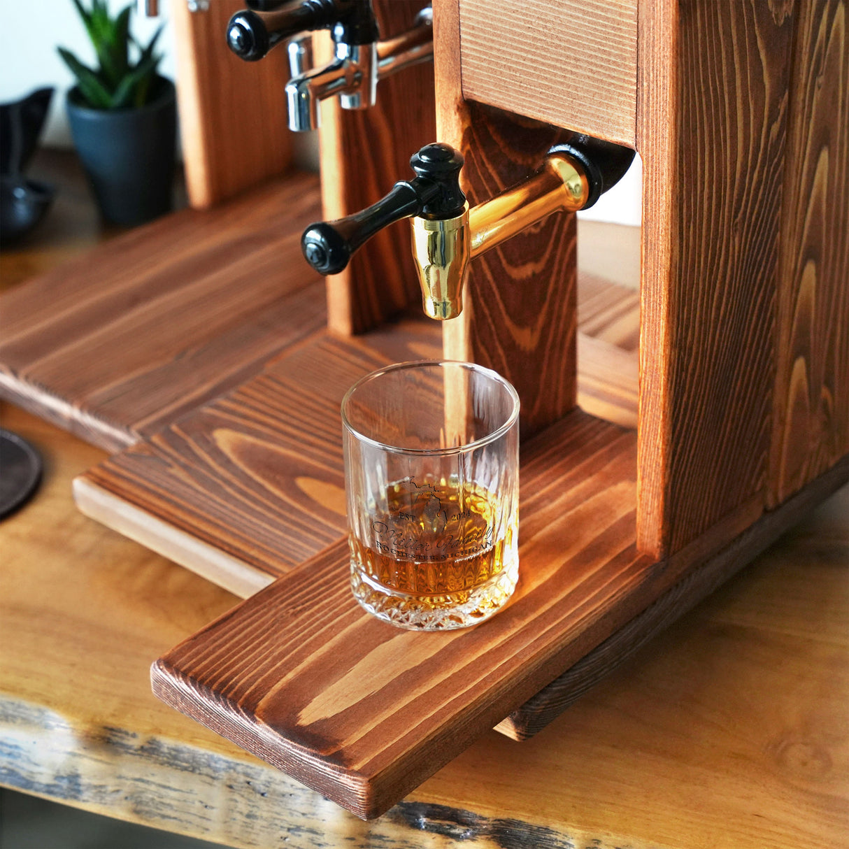 a glass filled with a liquid sitting on top of a wooden table